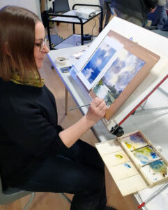 Liz Dowding painting a scene from Pooley Bridge, Ullswater