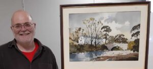 Artist Phil Biggs next to demonstration piece